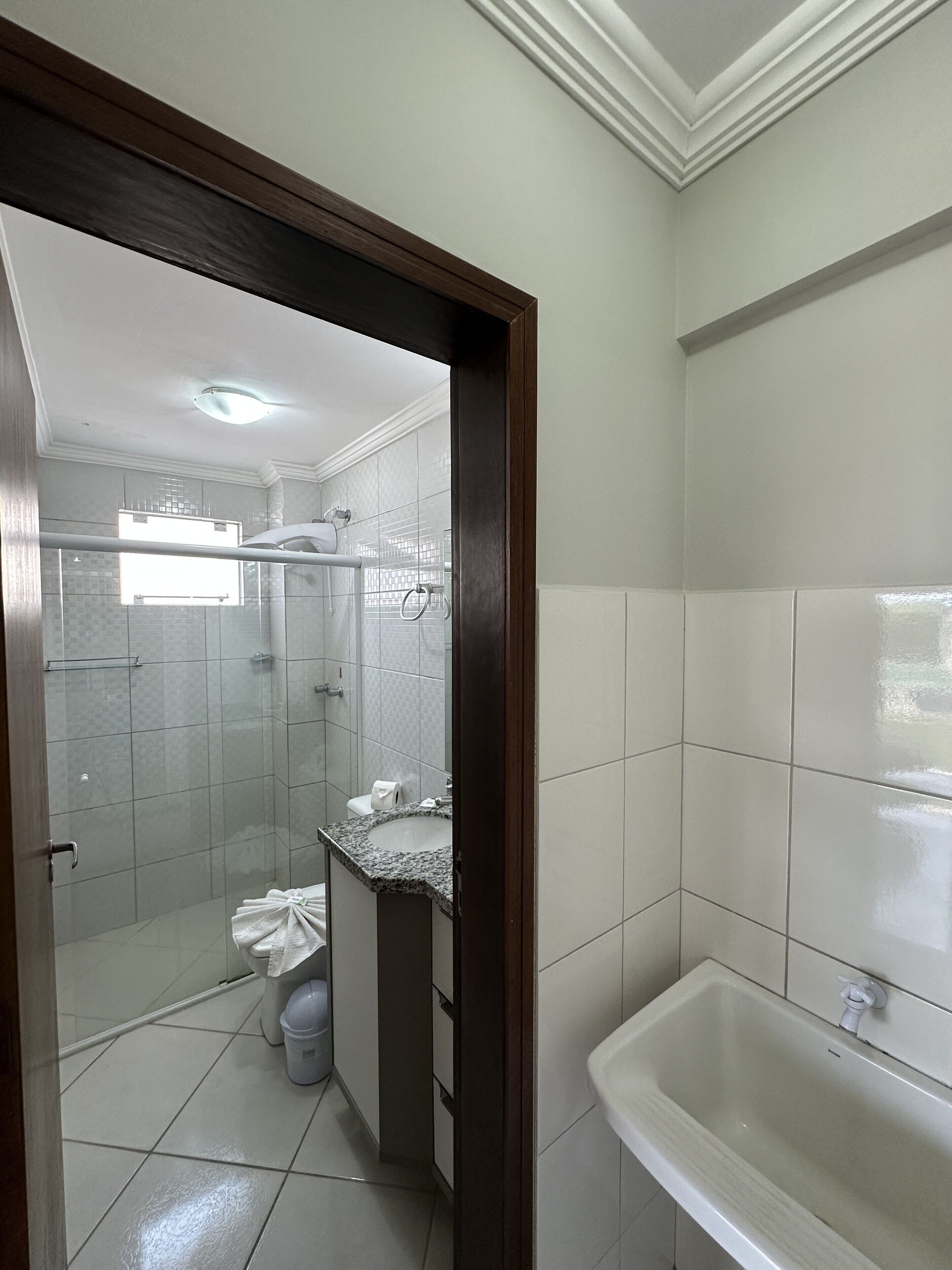A bathroom with a shower, toilet, sink, and bathtub.