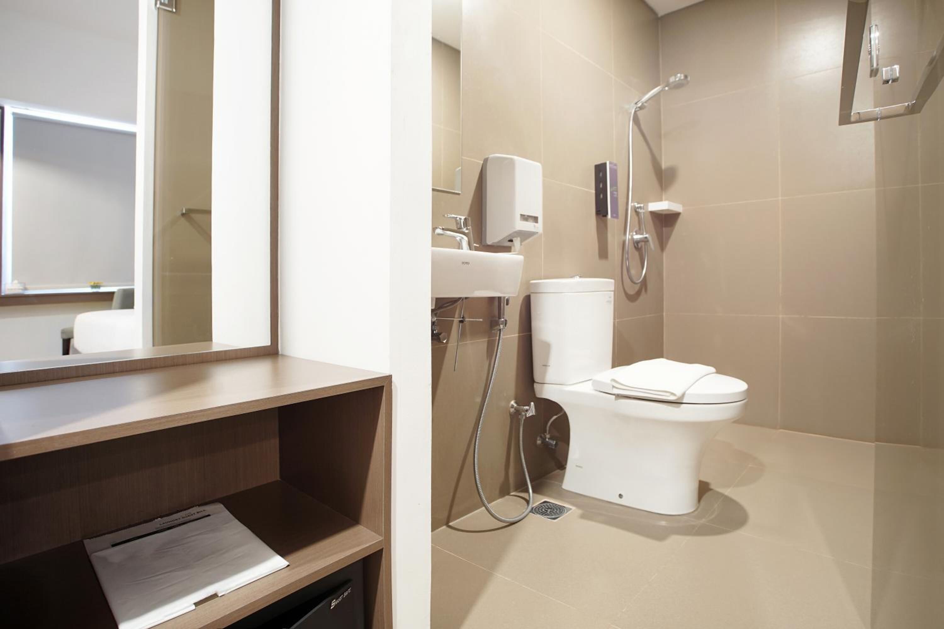 Un baño moderno con inodoro, ducha y lavamanos.