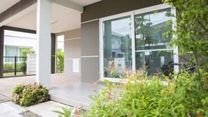 A modern building with large windows and a balcony. - Maximum Land & House with WiFi (Udon Thani)