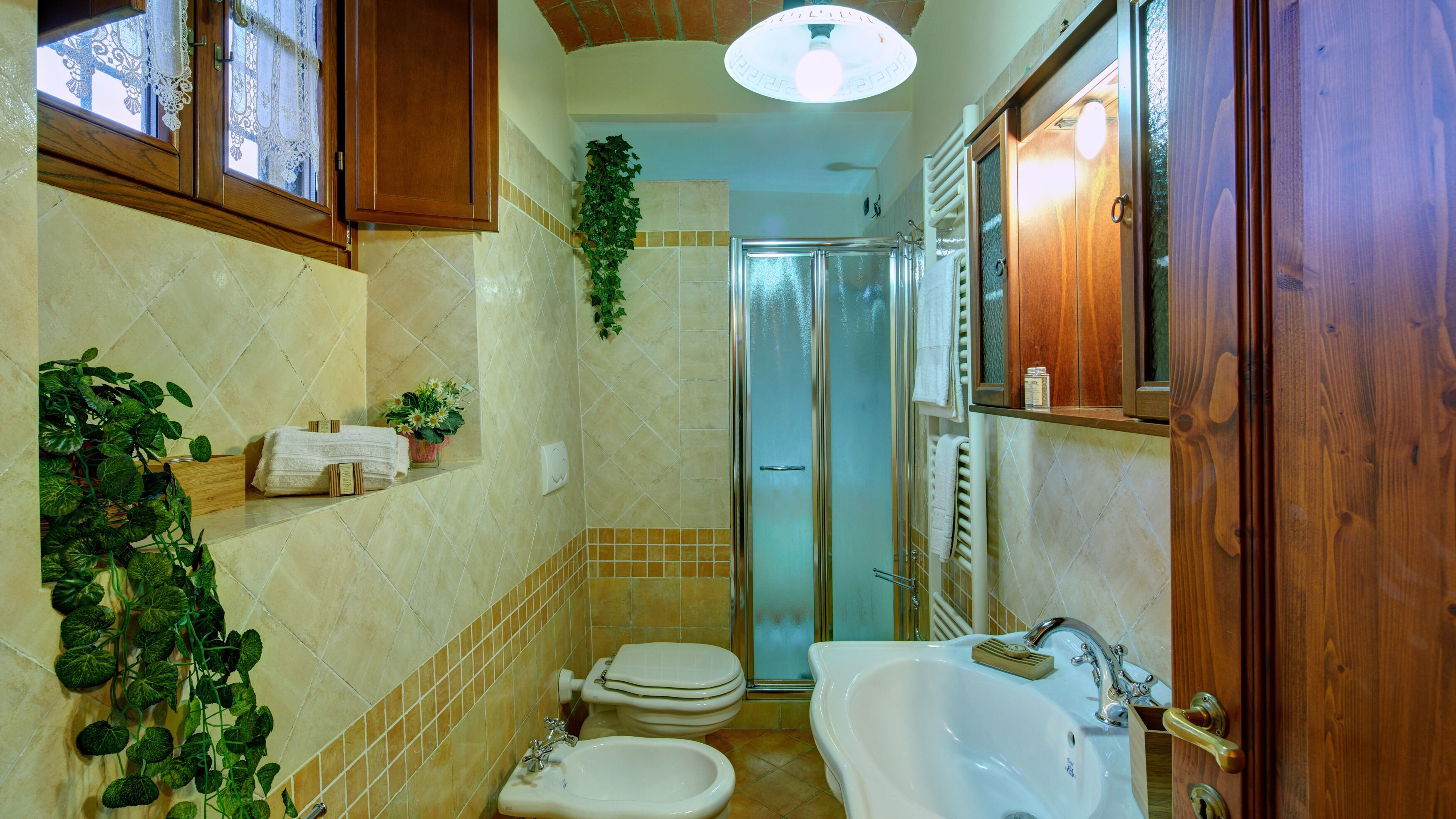A bathroom with a shower, toilet, and sink.