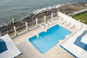 Outdoor pool, open 8:00 AM to 8:00 PM, pool umbrellas, pool loungers