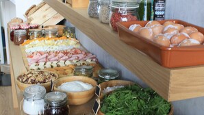 A buffet with various food items including meats, cheeses, and vegetables. - Qbic City Hotel (Larnaca)