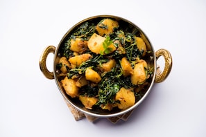 A bowl of food with a handle, placed on a surface. - OYO Flagship 561 Marol Naka Metro Station (Mumbai)