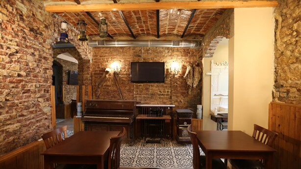 A rustic dining area with exposed brick walls, wooden furniture, and a large chimney. - Yeşilköy Airport Butik Otel (Istanbul)