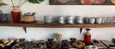 A buffet setup with various food items and serving ware.