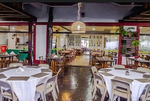 Enjoy meals in a spacious dining area with round tables and comfortable chairs.