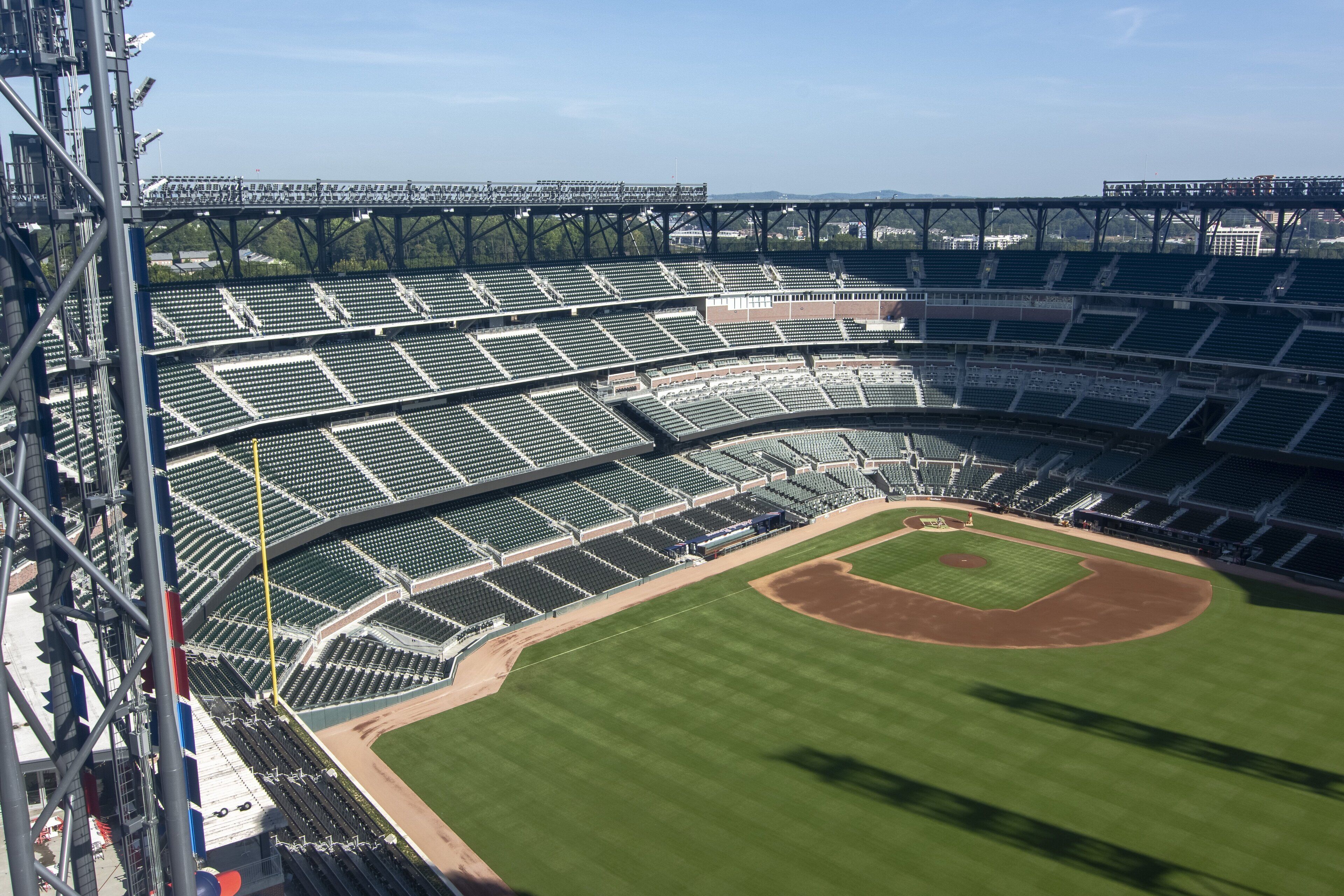 A large stadium with multiple tiers of seating and a baseball diamond.