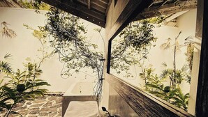 A bathroom with a stone floor, a sink, and a mirror. - Ceylon Olive (Galle)