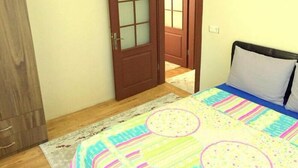 A bedroom with a bed, a wardrobe, and a door leading to another room.