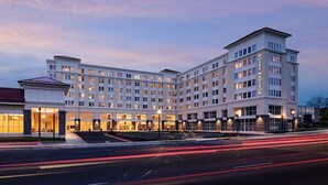 A multi-story hotel with a symmetrical facade, large windows, and a prominent entrance. - Hotel Madison & Shenandoah Conference Ctr (Harrisonburg)