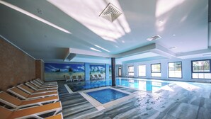 A swimming pool with lounge chairs, a mural, and a view of the outdoors. - Sey Beach Hotel & Spa (Alanya)