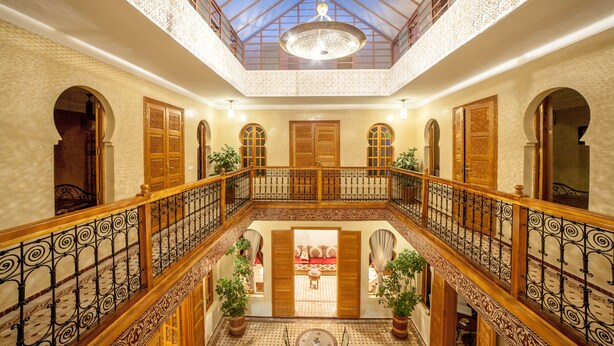 A spacious atrium with a high ceiling, ornate railings, and a central seating area. - Riad Dar Saidi (Rabat)