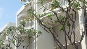 A modern building with multiple balconies and a gated entrance. - Baan Sea Talay (Cha-am)
