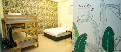 A room with a bunk bed, a single bed, a stone wall, and a wall with a leaf pattern.