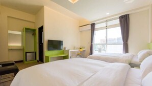 A hotel room with two beds, a TV, a desk, and a window with curtains. - Pandora Elevator B&B (Taitung)