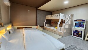 A hotel room with a bunk bed, a desk, a chair, and a gaming machine. - Gyeongju Kids & Family Hotel (Gyeongju)