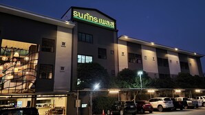 A building with a neon sign reading "Sunrise." - Thanaphat Place (Lam Plai Mat)