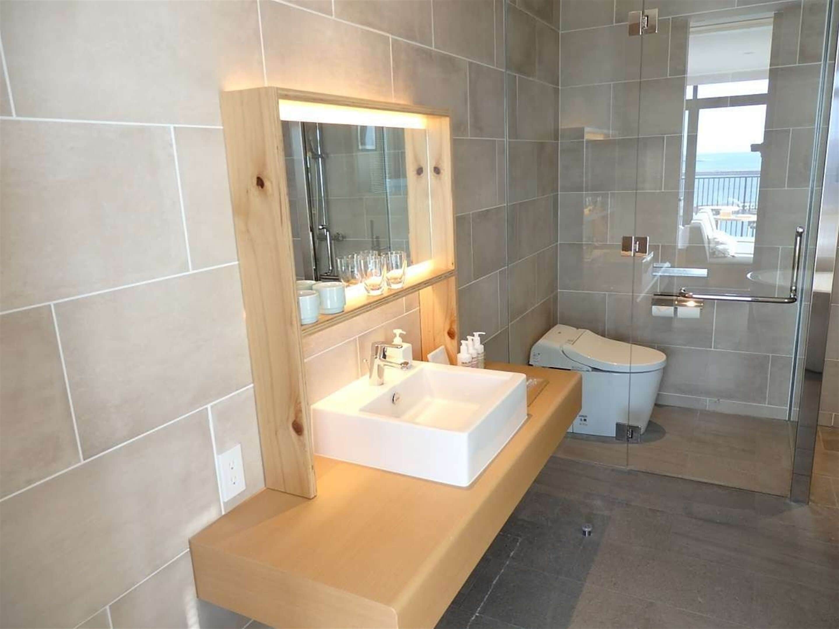 superior corner twin | bathroom | hair dryer, slippers, bidet, towels