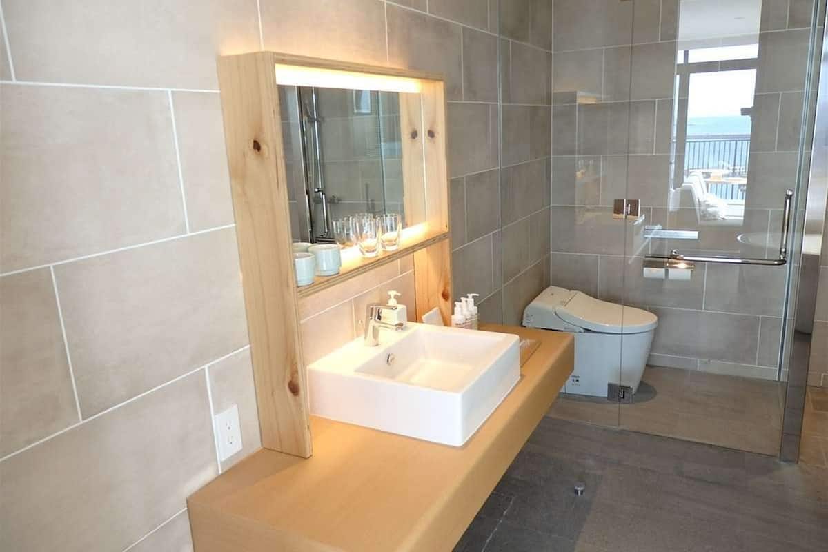 superior corner twin | bathroom | hair dryer, slippers, bidet, towels