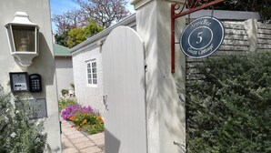 Una entrada cerrada a una cabaña de huéspedes con un letrero que dice 'Apple Bee 5 Guest Cottage'.