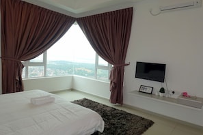 A bedroom with a bed, a TV, and a window with curtains. - D'Carlton Resort (Masai)