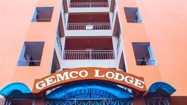 A building with a sign reading "Gemco Lodge" above a blue entrance. - Gemco Lodge (Embu)