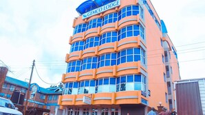 A multi-story building with a prominent sign reading "GEMCO LODGE". - Gemco Lodge (Embu)