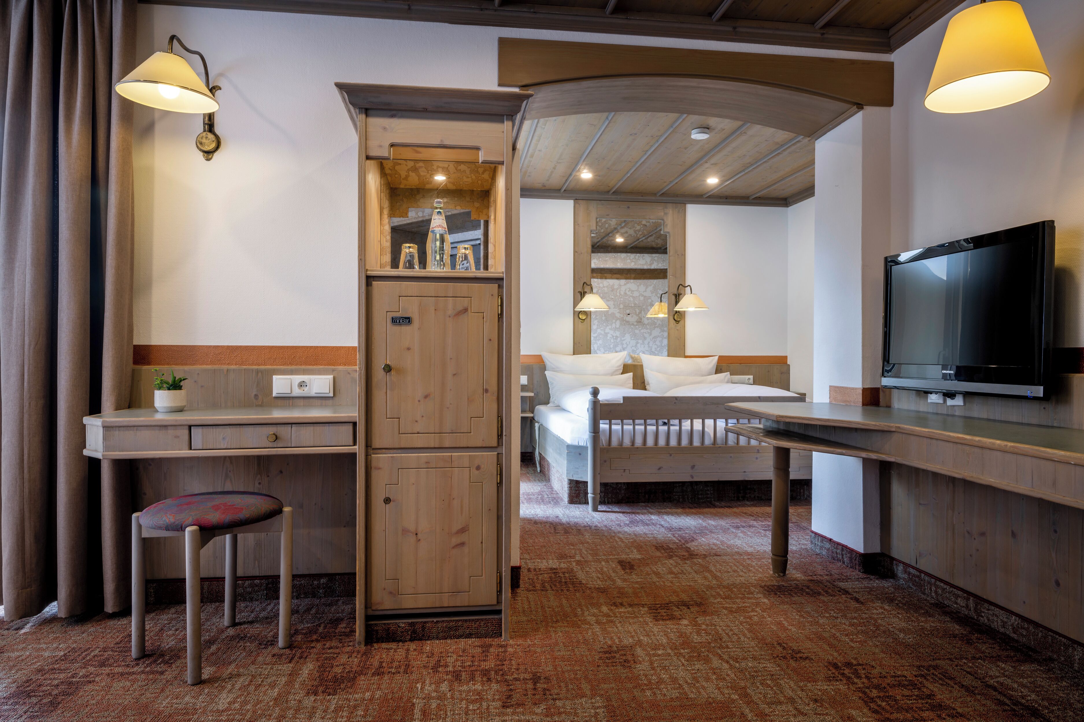 deluxe double room, balcony | living area | flat-screen tv