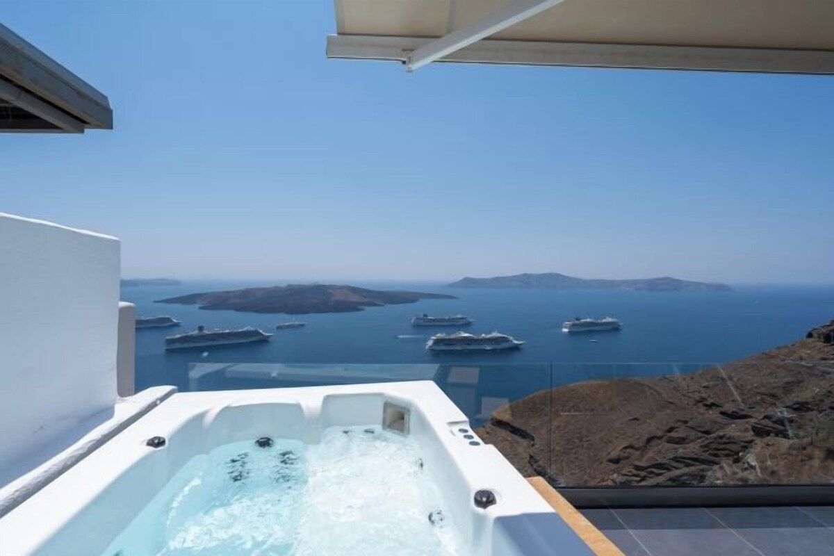 A hot tub with a view of the sea and boats.