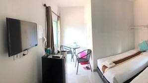 A hotel room with two beds, a desk, a chair, and a TV. - The Wish Residence (Udon Thani)