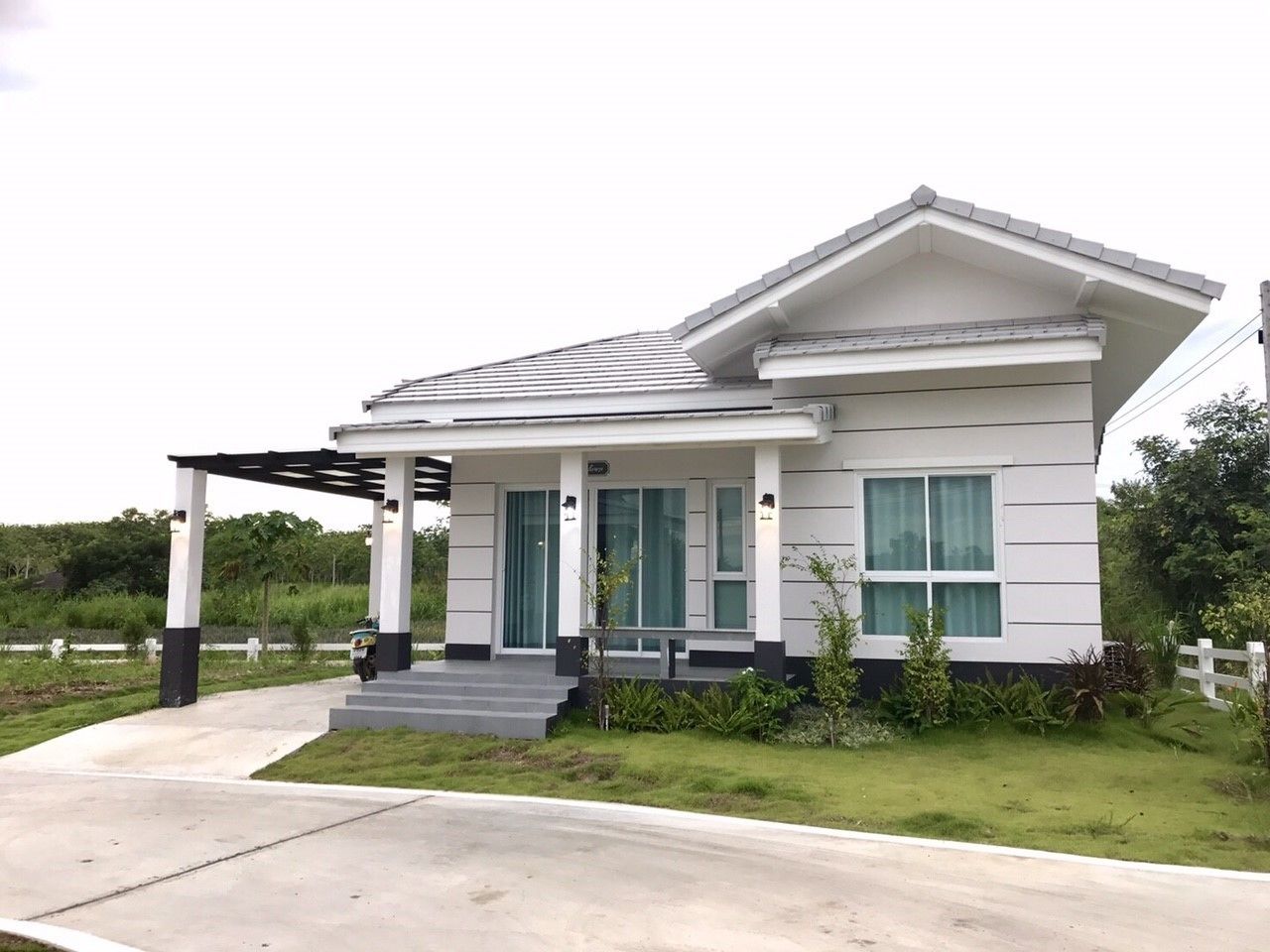 A modern two-story house with a covered porch, a front entrance, and a driveway.