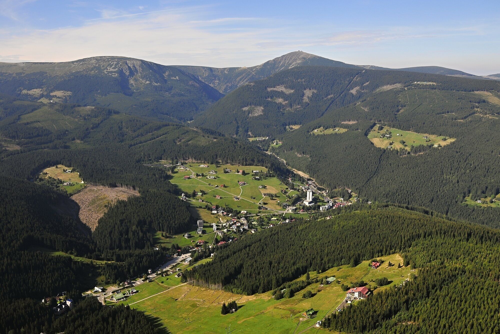 A mountainous landscape with a village nestled among the hills.