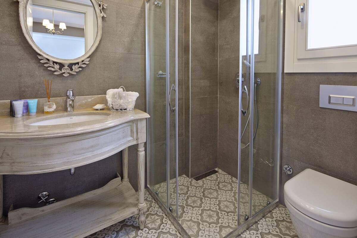 shower, designer toiletries, hair dryer, slippers