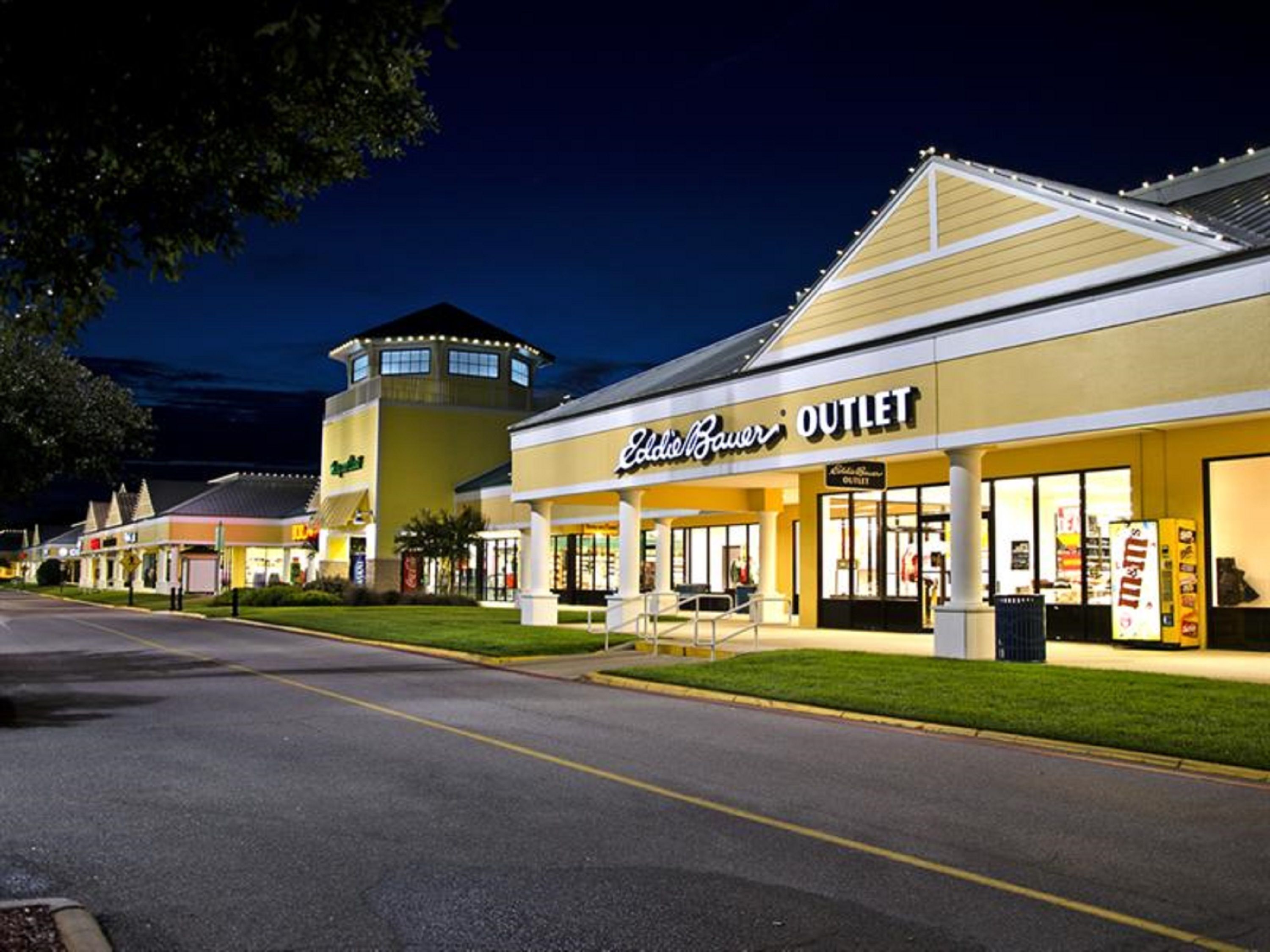 A commercial building with a storefront labeled "Outlet."