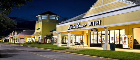 A commercial building with a storefront labeled "Outlet."
