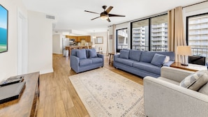 A modern living room with two sofas, a coffee table, a rug, and a ceiling fan. - Seaside Beach & Racquet 5614 (Orange Beach)