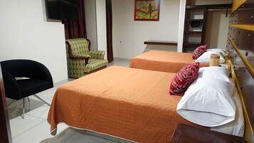 A hotel room with two beds, a TV, a chair, and a painting on the wall.