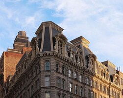 A historic building with ornate architectural details, including multiple windows and decorative elements on the facade.