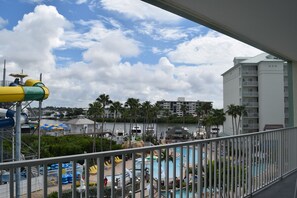 A hotel with a pool area, including a water slide and lounge chairs. - Harbourside Resort, a New Hotel Collection Property   (Indian Rocks Beach)