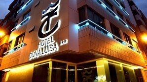 A modern hotel building with a prominent illuminated sign reading "HOTEL DONALUISA." - TC Hotel Doña Luisa (Las Palmas de Gran Canaria)