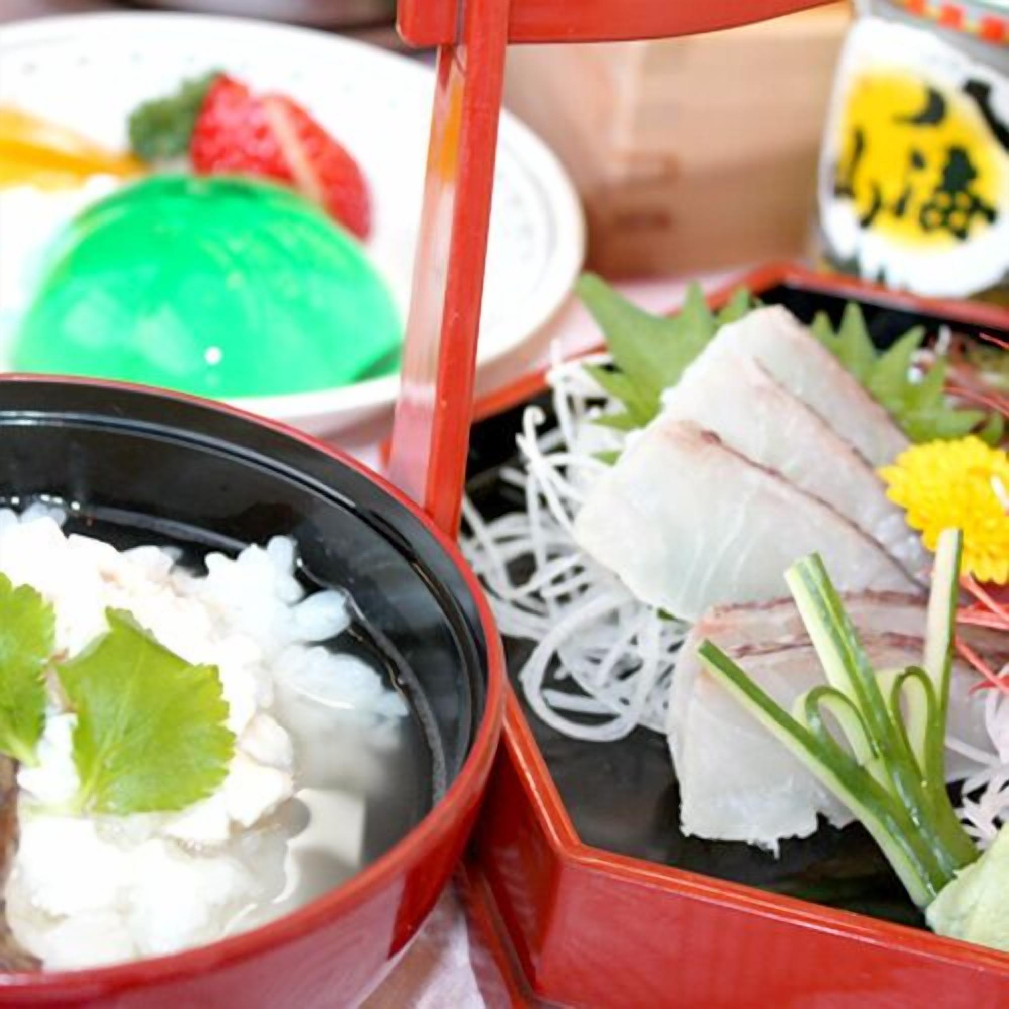 A traditional Japanese meal with rice, fish, and vegetables.
