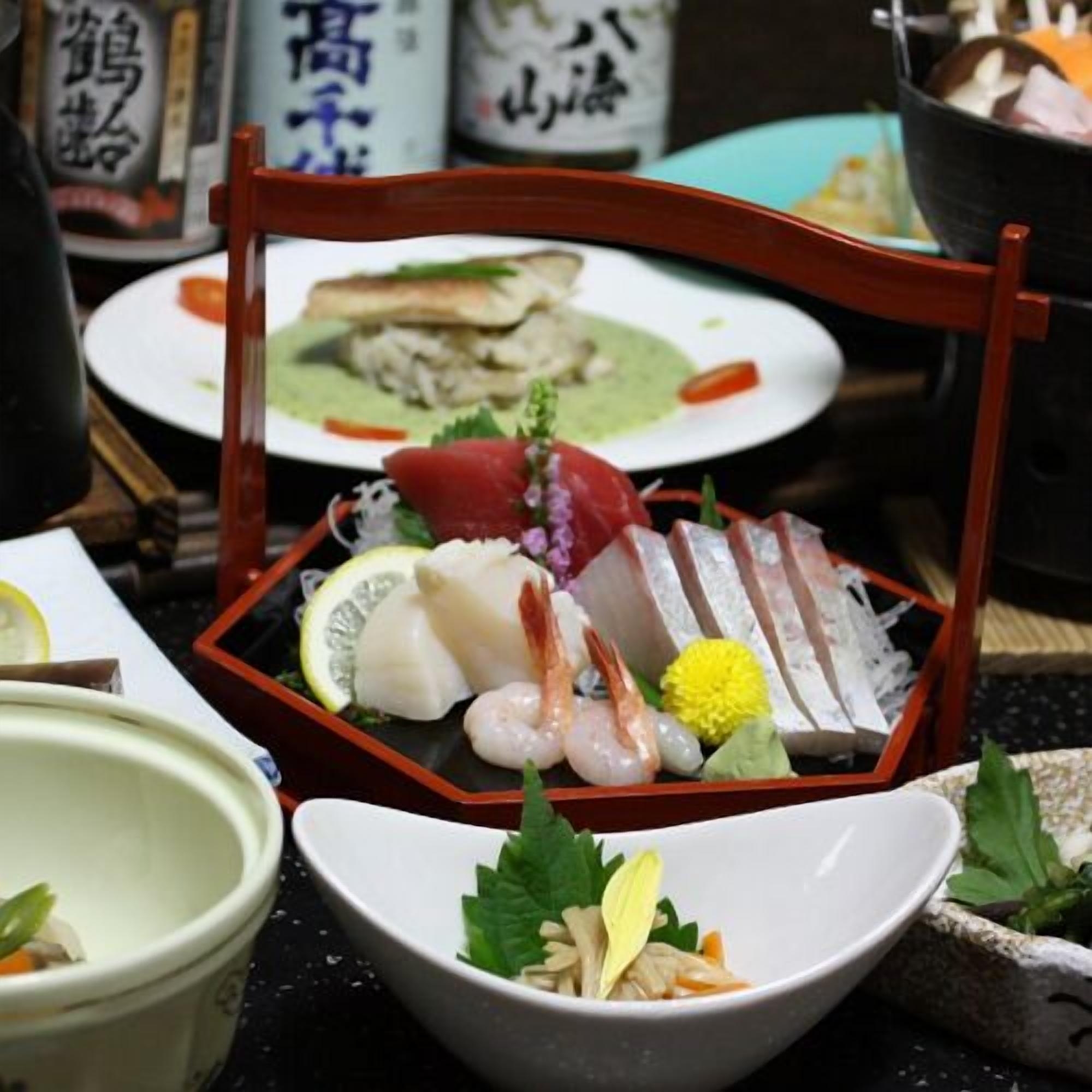 A traditional Japanese meal with sashimi and sushi on a wooden tray.