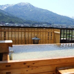 A wooden deck with a view of a mountain range.