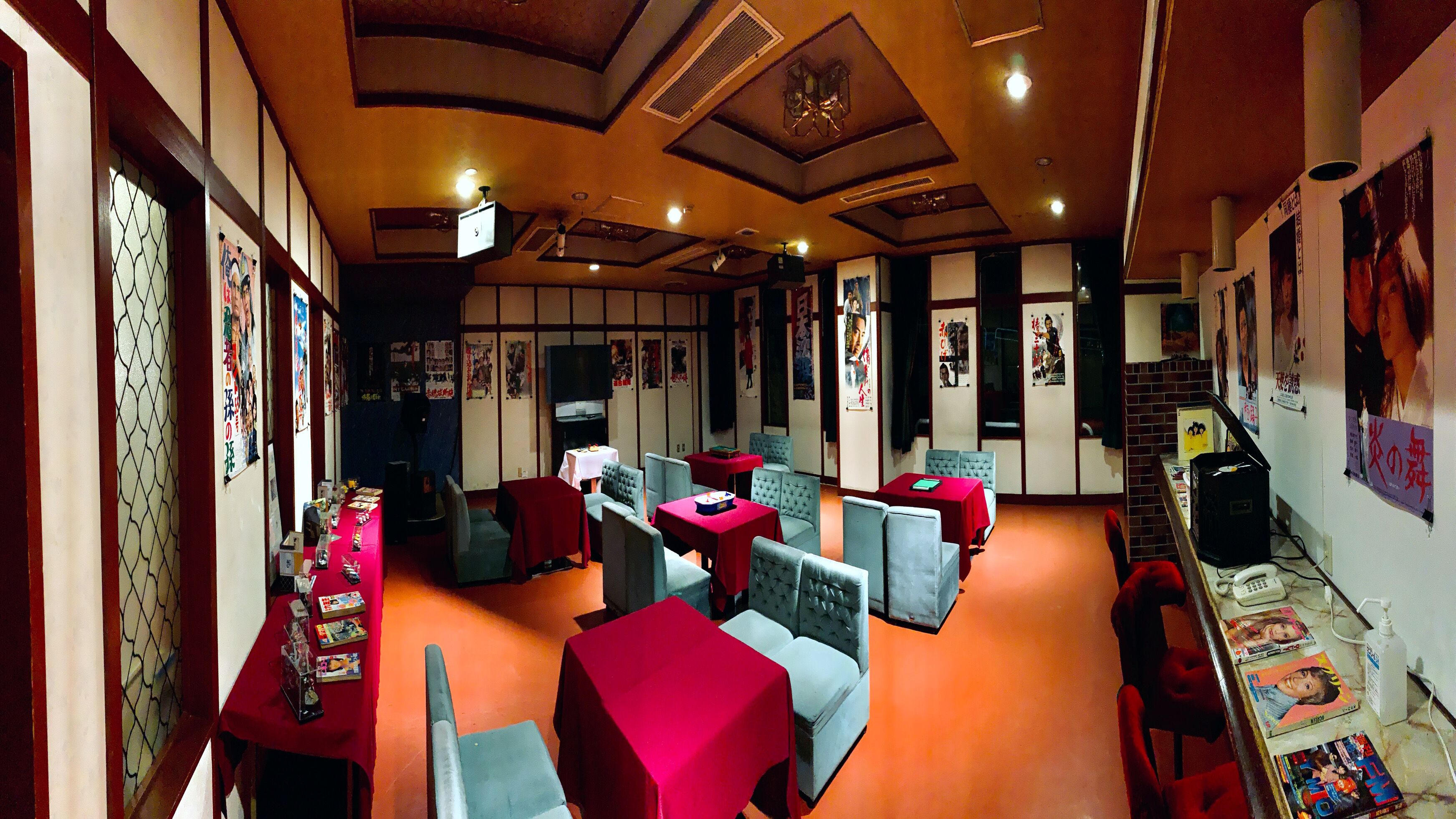 A traditional Japanese-style room with tatami flooring, low tables, and cushions.