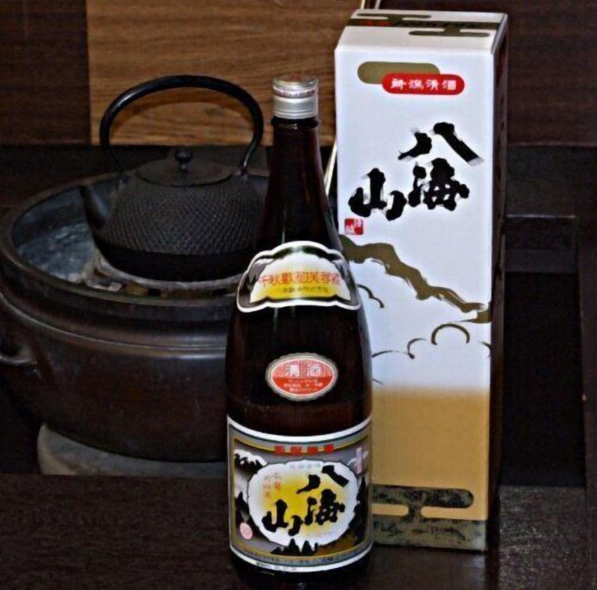 A bottle of soy sauce with a label and a box with Chinese characters.