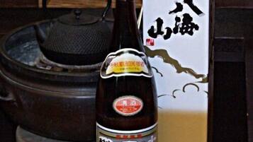 A bottle of soy sauce with a label and a box with Chinese characters.
