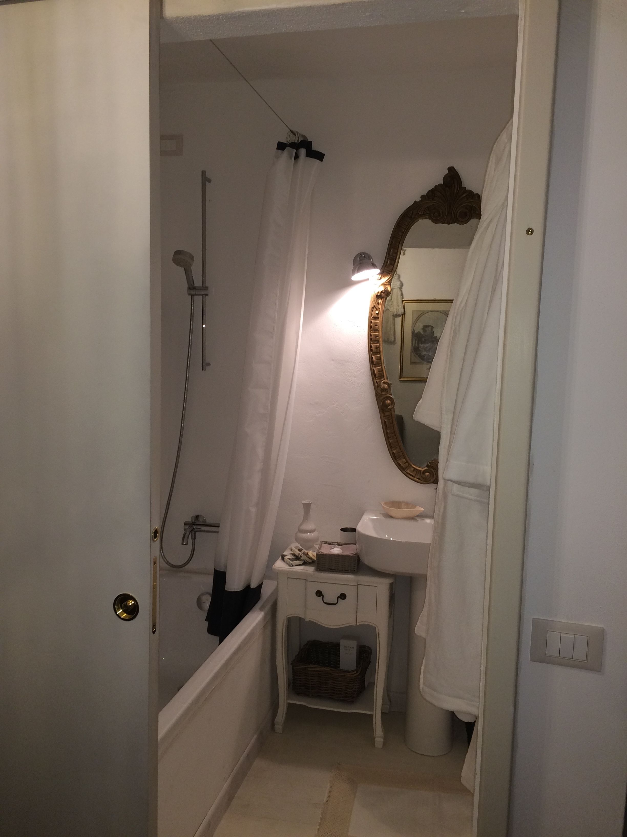 A bathroom with a bathtub, a sink, a mirror, and a shower.