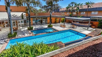 Outdoor pool, open 6:00 AM to 10:00 PM, pool loungers