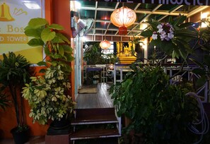 A hotel entrance with a staircase leading to a reception area, surrounded by potted plants and a sign reading "The Boss Tower". - The Boss Grand Tower Hotel (Khon Kaen)