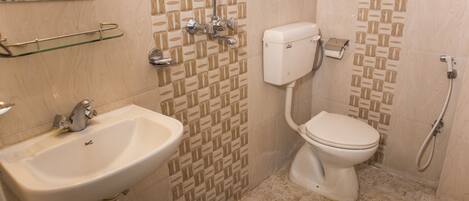 A bathroom with a sink, toilet, and shower.